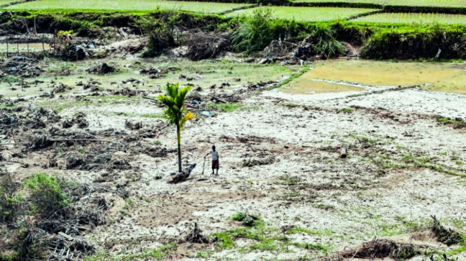 Survivors pick up pieces in flood-hit Indonesia as more rain predicted